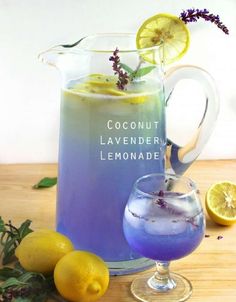 a pitcher of lavender lemonade next to some lemons