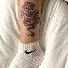 a person with a dragon tattoo on their arm