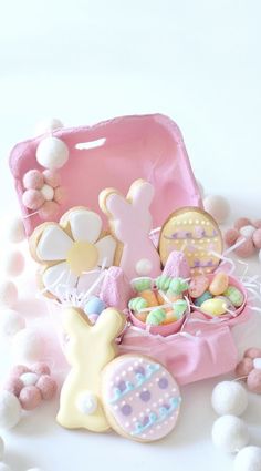 a pink box filled with lots of cookies and candies