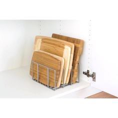 a bunch of cutting boards sitting on top of a shelf