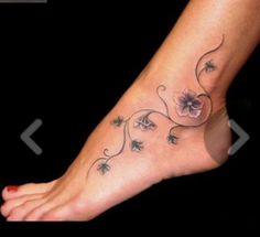 a woman's foot with flowers on it