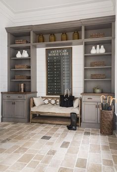 a living room filled with furniture and lots of shelves