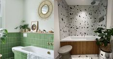 the bathroom is decorated in green and white tile, while the bathtub has been painted with black spots