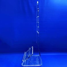 a clear acrylic display stand on a blue background