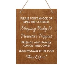 a wooden sign that says, please don't knock or ring the doorbell sleeping baby & protective puppies friends and family always welcome