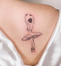 a woman with a ballerina tattoo on her back