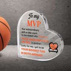 an acrylic heart shaped award with a basketball