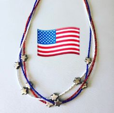 The stars on the U.S. flag represent the 50 states as well as a symbol of the heavens and the divine goal to which man has aspired from time immemorial.  Carry that symbol with you this 4th of July with a 24-inch triple wire strung necklace made with 2mm red, white and blue seed beads, and 8mm wide star shaped beads.  Necklace is secured with beads cover tips, crimp beads, and barrel clasp.  Wear your stars proudly. Will be shipped in mesh bag for that special someone😁 Patriotic American Flag Jewelry For Independence Day, Patriotic American Flag Jewelry For 4th Of July, Art Nouveau Necklaces, The 50 States, Crimp Beads, 50 States, Mesh Bag, Beads Necklace, Star Necklace