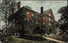 an old building with ivy growing on it's sides and trees in the foreground