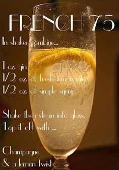 a glass filled with water and lemon on top of a table