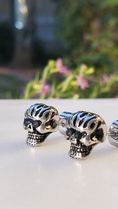 Description: Embrace a rebellious and edgy style with these Stainless Steel Black Cz Girls Biker Skull Stud Earrings. Crafted for those who love to make a statement, these earrings bring together toughness and glamour in a unique design. Product Features: Stainless Steel Construction: The earrings are made from durable stainless steel, ensuring longevity and resistance to tarnish. Black Cubic Zirconia Accents: The black cubic zirconia stones add a touch of darkness and sparkle, creating a bold and distinctive look. Biker Skull Design: The skull motif gives these earrings a rebellious and biker-inspired aesthetic, perfect for those with a daring sense of style. Stud Style: The stud design makes these earrings easy to wear daily, adding a hint of attitude to your look. Versatile Accessory: W Skull Print Gothic Jewelry For Streetwear, Black Skull-shaped Earrings With Skull Print, Edgy Nickel-free Skull Earrings, Edgy Skull-shaped Pierced Earrings, Black Gothic Earrings With Skull Print, Edgy Pierced Skull Jewelry, Black Skull Print Jewelry For Streetwear, Silver Rocker Jewelry With Studs, Edgy Silver Jewelry For Biker Events