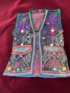 child vest i purchased in Upper Swat Valley 1990s  these are unique one of a kind pieces mothers made for their little boys . This is not done anymore and hard to find old pieces Handmade Folk Style Vest For Festivals, Folk Style Multicolor Festival Vest, Handmade Folk Vest For Festivals, Handmade Bohemian Festival Vest, Handmade Bohemian Vest For Festival, Bohemian Festival Vest, Bohemian Multicolor Embroidered Vest For Festivals, Handmade Multicolor Vest For Festival, Bohemian Embroidered Festival Vest