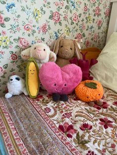 several stuffed animals sitting on top of a bed