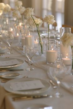 White roses in bud cases along with sand candles are the perfect mix for a elegant affair. Each table was draped in a textured white linen and featured custom black and white wedding menus. Photo: Emily Magers, Venue: Park Hyatt Aviara, Florist: Angelical Flowers, Menus: Signed by Shaun Sand Candles Wedding, Bud Vases And Candles Long Table, Roses In Bud Vases, Bud Vases And Candles, White Bud Vases, European Inspired Wedding, Bud Vases Wedding, Classic Wedding Reception, Classic Timeless Wedding