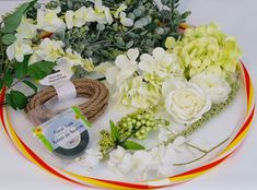 flowers are arranged on a plate with rope