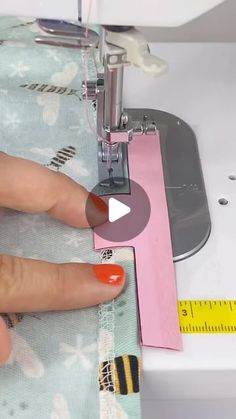 a woman is using a sewing machine to sew on her hand and the needle has been