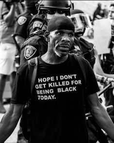 a man wearing a t - shirt that says hope i don't get killed for being black today