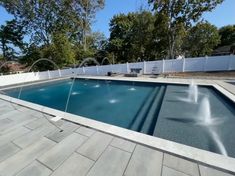 an empty swimming pool with water spouting from it