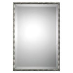 a silver framed mirror with beaded trim around the edges and an ornate border on the edge