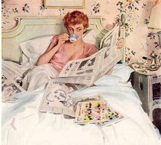 a woman laying in bed reading a newspaper and drinking from a cup with her hand