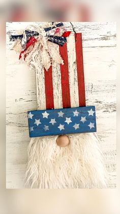 a wooden sign with an american flag on it's face and a santa clause beard