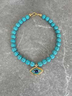 Handcrafted by IJ Design Boutique 🤍🌟 Made in Uk Made of: * Turquoise beads * Handmade painted ceramic evil eye pendant * 18k gold-filled details  * Anti-allergenic * Long lasting * Heavy  Length customized. -IJ DESIGN BOUTIQUE- From necklaces to earrings, we make jewellery using a wide range of materials. From silver and gold plated to freshwater pearls and real gemstones.  Our collections are all based on the latest trends in jewellery along with classic pieces which won't date. You are able Handmade Turquoise Choker Necklace, Evil Eye Choker Necklace As Gift, Evil Eye Choker Necklace For Gift, Turquoise Evil Eye Bracelet Jewelry, Unique Evil Eye Jewelry For Festival, Spiritual Blue Choker Jewelry, Handmade Blue Turquoise Choker Necklace, Turquoise Evil Eye Bracelet, Bohemian Turquoise Evil Eye Necklace