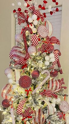 a christmas tree decorated with red and white ornaments