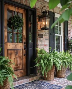 the front door is decorated with plants and potted plants