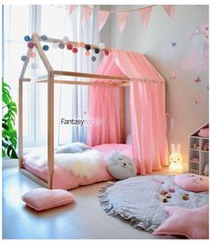 a bedroom with pink and white decor on the walls