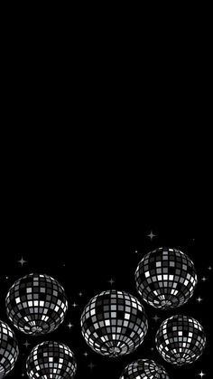 several disco balls in the middle of a black background