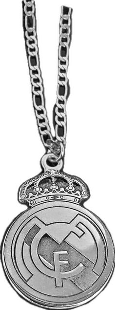 a silver necklace with the emblem of real madrid on it's front and back sides