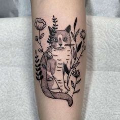 a black and white cat tattoo on the leg