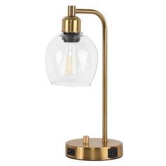 a brass table lamp with a glass globe shade