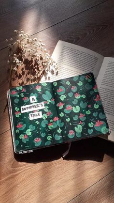 an open book sitting on top of a wooden floor