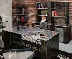 an office with brick walls and metal desks, bookshelves, and chairs