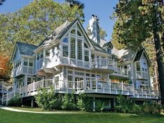 a large white house with lots of windows and balconies on the top floor