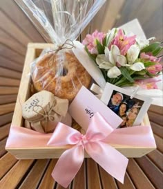 a basket filled with cookies and flowers on top of a wooden table