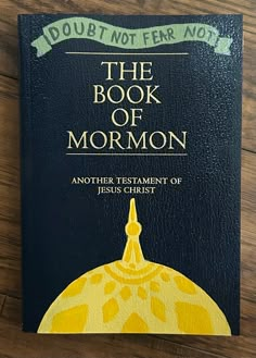 the book of mormon on a wooden table