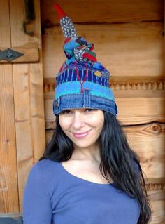 a woman wearing a blue hat with birds on it's head and smiling at the camera