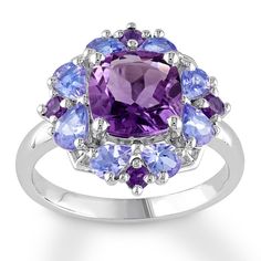 A cushion-cut amethyst encircled by pear-shaped tanzanites and round amethysts creates a spectacular display in this dramatic ring for her. The band is styled in sterling silver. Silver Flower Ring, Amethyst Set, Tanzanite Ring, Amethyst Jewelry, Sterling Silver Flowers, Flower Ring, Silver Flowers, Jewellery Collection, Amethyst Ring