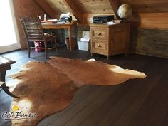 a cow hide rug in the corner of a room