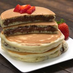 stack of pancakes with chocolate and strawberries on top