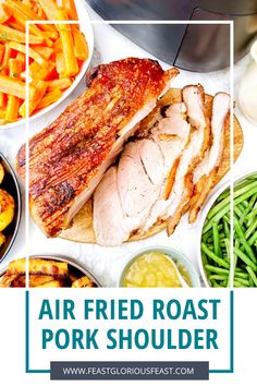 an air fried roast pork shoulder surrounded by vegetables and other foods on a white table