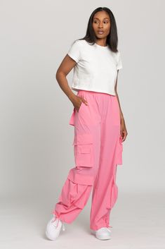 NEW Limited Edition & custom designed Pink Parachute Pants! Not only did we spend months designing these amazing cargo style pants, but we PERFECTED them in the process! These pants are insanely versatile due to their lightweight material and trendy style. They feature adjustable ankle cuffs that you can leave wide or tie up for a jogger look. The elastic waist-band allows for a comfortable fit and the multiple pockets provide great functionality. These pants easily can be worn for any workout o Pink Parachute Pants With Cargo Pockets For Streetwear, Pink Straight Cargo Pants, Summer Pink Parachute Pants With Cargo Pockets, Pink Cargo Style Parachute Pants, Trendy Summer Nylon Cargo Pants, Trendy Nylon Parachute Cargo Pants, Trendy Nylon Cargo Pants For Summer, Trendy Parachute Pants With Cargo Style, Trendy Loose-fit Cargo Parachute Pants