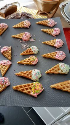 some waffles with ice cream and sprinkles are on a baking sheet