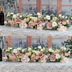 two shelves with flowers and wine bottles on them