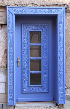 a blue door with glass on the outside