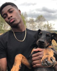 a young man holding a dog in his arms