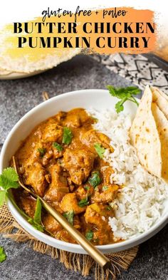 a white bowl filled with chicken curry next to rice and tortilla on a table