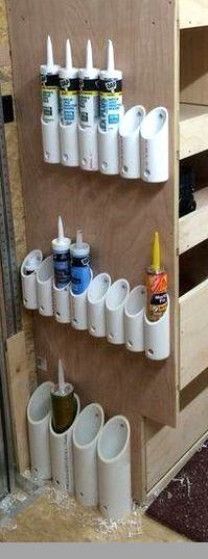 there are many cups on the wall with toothbrushes and glues in them